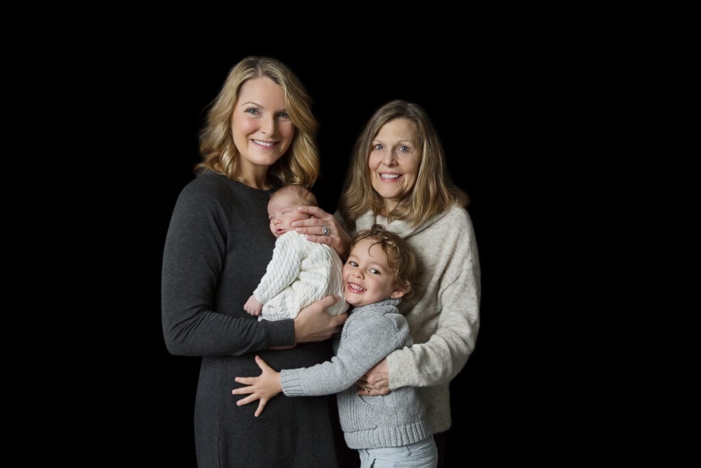 Three-generation family portrait with newborn, toddler, mom, and grandmother — McLean newborn photography