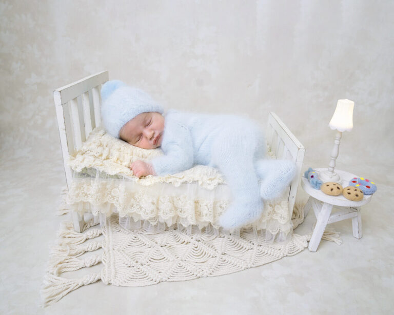 newborn baby laying in bed for newborn photography