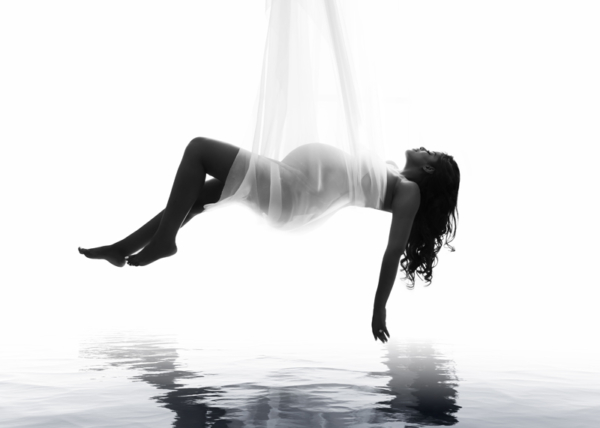 Floating in Light — Aerial Maternity Fine Art Pregnant Black woman in a white maternity gown