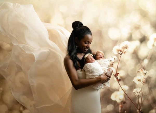Mother holding twin newborn baby girls in lace wraps and flower headbands &mdash; Washington DC newborn photography.
