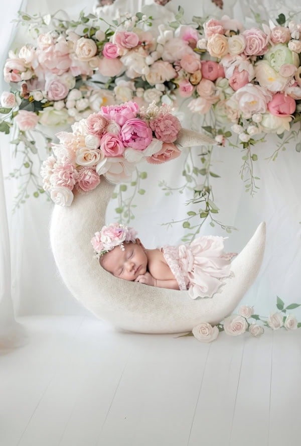 Baby girl on crescent moon with pink flowers &mdash; Washington DC newborn photography.